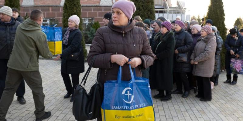  A crowd gathers for a Samaritan's Purse food distribution at a local church. With factories closed, people have come to rely on aid.