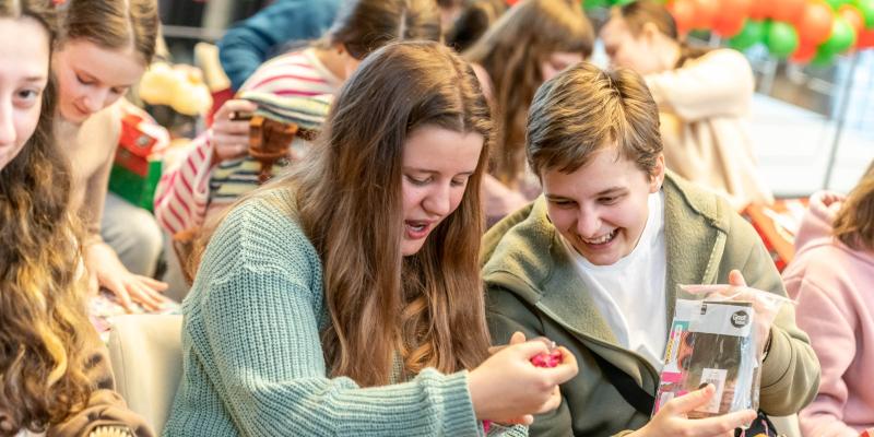 smiling teens as they explore shoebox gift