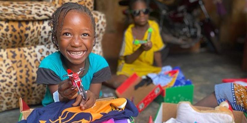 excited child sitting with shoebox