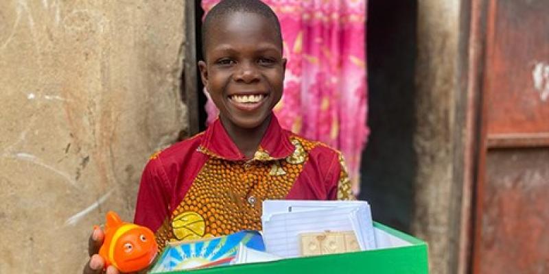 boy holds new ball from shoebox