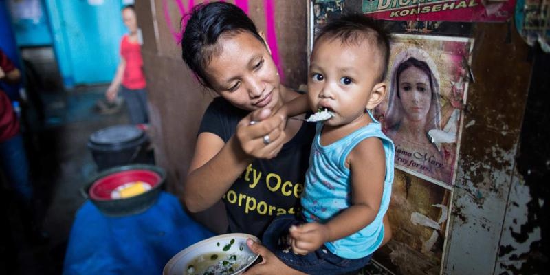 Woman feeding her child