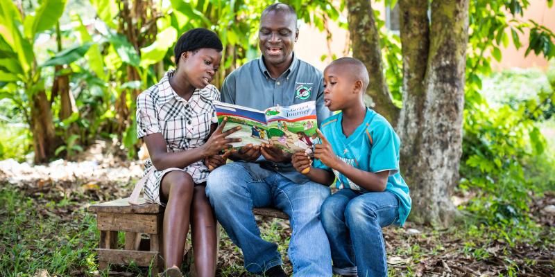 Volunteer reading The Greatest Journey to Kids