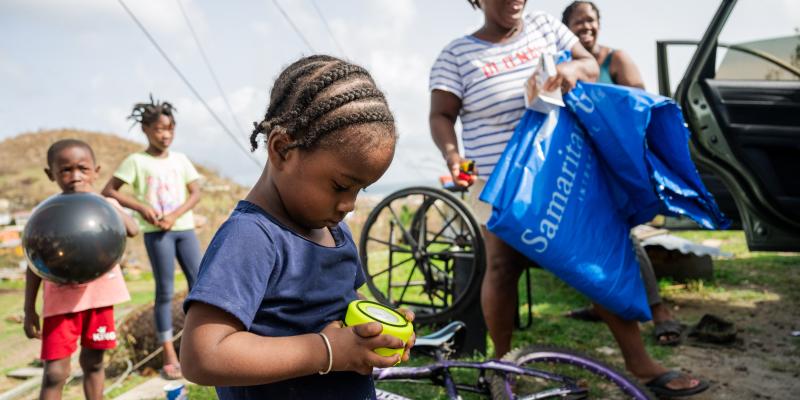 A CHILD LEARNS HOW TO OPERATE HIS FAMILY’S SOLAR-POWERED LIGHT.