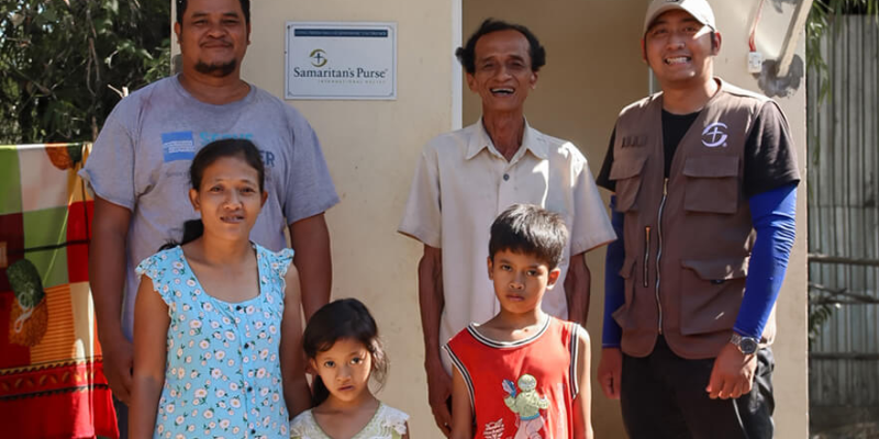 CUONG, UPPER LEFT, AND HIS FAMILY CAN ENJOY A SANITARY BATHROOM AND SHOWER NOW THAT WATER REACHES THEIR PROPERTY.