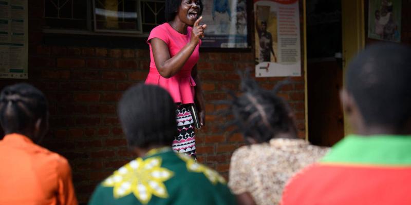 After Frank's prayer, Janet shares the Gospel with the patients.