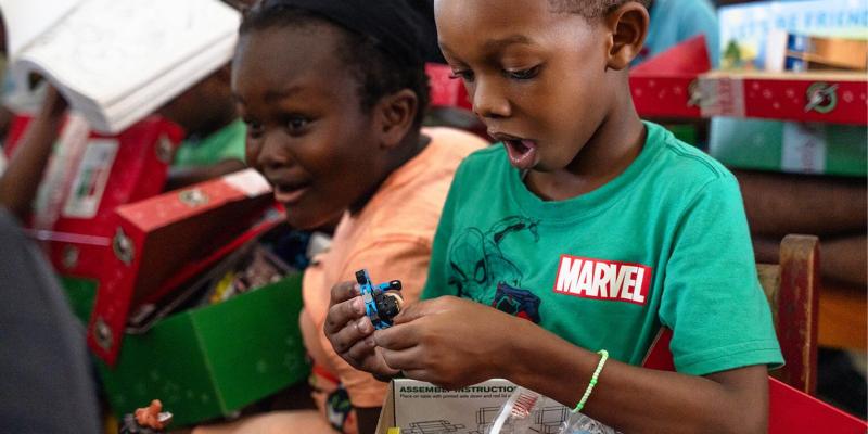 Boys in Grenada are amazed when they see the toys in their shoeboxes.