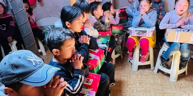 These children were led in a prayer after they received their shoebox gifts.