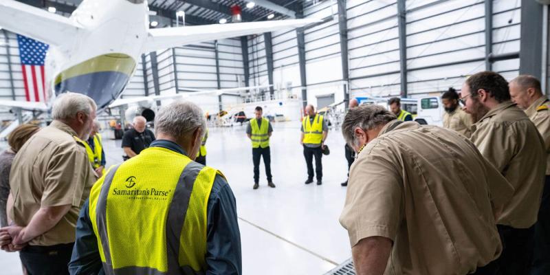Members of our Mission Aviation Services team pause to pray before the 767 left our Greensboro, North Carolina, hangar early Monday morning.
