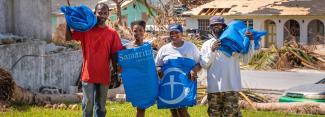 family after hurricane with tarp