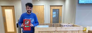Student dropping off a shoebox