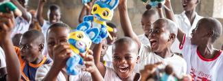 Children wave bunnies donated as gifts in kind