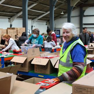 smiling volunteer wearing high vis jacket