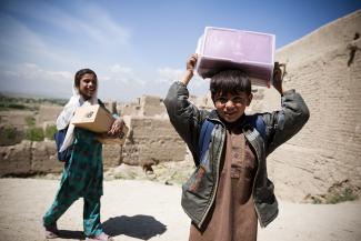 boy hold shoebox on head