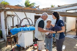 Samaritan's Purse volunteers praying with a woman