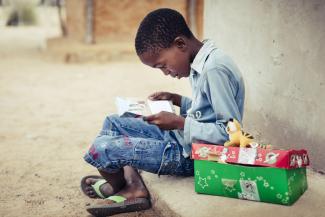 Young boy reading The Greatest Journey