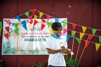 GLENN EXCITED TO RECEIVE HIS NEW BIBLE DURING THE GRADUATION CEREMONY