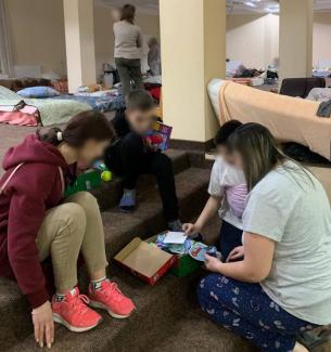 Children exploring their gifts at a refugee centre