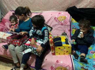 family receiving shoebox gifts