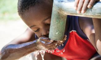 Child drinking clean water from a tap