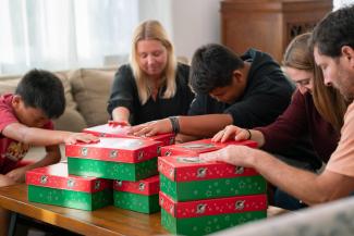 People praying for the shoeboxes