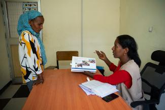 SAMRAWIT TALKS WITH A SAMARITAN’S PURSE TRAUMA RECOVERY TEAM MEMBER.