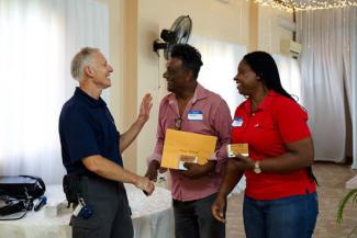 PASTOR JUNIOR AND HIS WIFE GREET GREG PISESKY OF SAMARITAN’S PURSE.