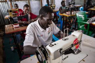 Through our tailoring class, displaced men and women are learning to sew and to smile again.