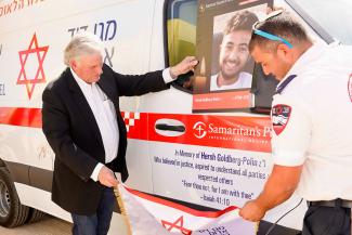 Franklin Graham stands with the ambulance dedicated in memory of Hersh Goldberg-Polin, who was taken hostage and then murdered by Hamas.