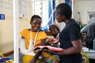 Janet, right, shares truth from Scripture following the surgery on Ireen’s elbow.