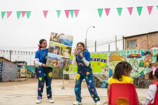 Kelly (center) tells children stories about Jesus from the Bible during a Gospel presentation.