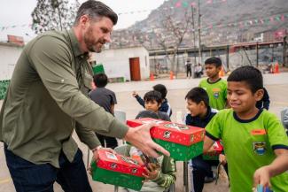 Peruvian children delight in receiving a gift-filled shoebox from Edward Graham.