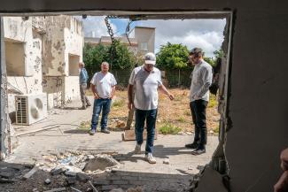 Edward Graham surveys damage from Hezbollah missile strikes in the village of Arab al-Aramshe.