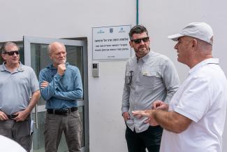 Graham and Ken Isaacs, vice president of programs and government relations (second from left), talk with a local leader in the village of Arab al-Aramshe.