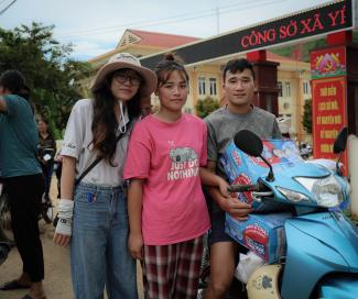 Mai (center) and her husband departed the Samaritan’s Purse distribution site with a newfound sense of hope, and relief supplies piled on their motorcycle.