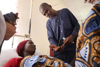 Pastor Babangida shares the Gospel with an ethnically Fulani woman, and gifts her with an audio Bible in her heart language, Fulfulde, provided by Samaritan’s Purse.