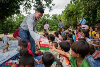 Nisay delivers shoebox gifts at an Operation Christmas Child outreach event where the Gospel is clearly shared.