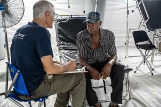 Lasbourne Ricketts meets with Samaritan’s Purse medical staff after losing his home and access to regular care in the storm.