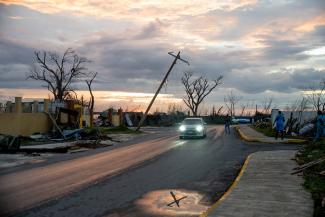 Families walked their neighbourhoods at dusk, taking in the wreckage that Hurricane Melissa left behind.