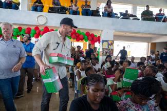 Edward Graham, joined by Jonathan Falwell and other Liberty University leadership, helps distribute Operation Christmas Child shoebox gifts to children in Black River as families continue recovering from Hurricane Melissa.