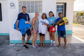 Loida (centre) thanks God for Samaritan’s Purse, and Pastor Chad (far left) and his wife, Angela (middle left). Each generator distributed comes with a power block, 100-foot extension cord, gas can, and engine oil.