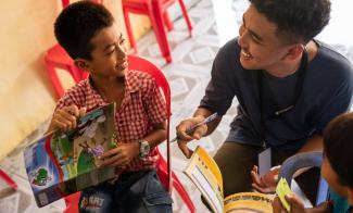 Though he never wanted to be a teacher, Sann (right) today finds great joy in training young Cambodians in the 12 Bible lessons of the The Greatest Journey.