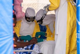 Samaritan's Purse and local medical personnel in personal protective equipment treat a patient at our Ebola Treatment Centre in Bunia.