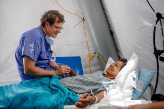 Dr. Cooper meets with a surgical patient at our field hospital where our team has completed more than 200 surgical procedures since the June 24 earthquake that destroyed large portions of La Guaira.