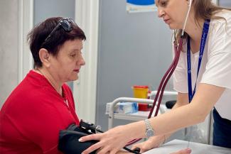 A nurse checks Nadia’s blood pressure, which once elevated, has now stabilized with the help of our staff.